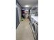 Efficient laundry room featuring white appliances and storage shelving for organized convenience at 424 Forest Glen Ave, Lakeland, FL 33813