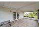 Enclosed screened patio with tile flooring, with view to back yard and doors to interior at 424 Forest Glen Ave, Lakeland, FL 33813