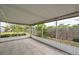 Screened-in patio with tile flooring, providing a serene view of the landscaped backyard at 424 Forest Glen Ave, Lakeland, FL 33813