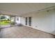 Enclosed screened patio with tile flooring, with view to back yard and doors to interior at 424 Forest Glen Ave, Lakeland, FL 33813