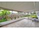 Enclosed patio with tiled floor and view of the backyard garden at 424 Forest Glen Ave, Lakeland, FL 33813