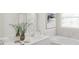 This bathroom boasts white cabinets, a large vanity mirror, and a soaking tub at 4692 Coral Harbour Rd, Kissimmee, FL 34758