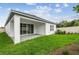 A view of the backyard showcasing the lush green lawn, patio, and house at 5914 Bristle Oak St, Mount Dora, FL 32757