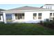 Well-maintained backyard with lush green grass and a covered patio area at 5914 Bristle Oak St, Mount Dora, FL 32757