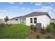 Backyard view showcasing lush lawn, white fencing, and the home's exterior at 5914 Bristle Oak St, Mount Dora, FL 32757
