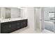 Bathroom featuring double sinks, a vanity, and access to a bedroom at 5914 Bristle Oak St, Mount Dora, FL 32757