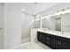 Modern bathroom featuring double sinks, vanity, and frameless glass shower at 5914 Bristle Oak St, Mount Dora, FL 32757