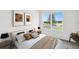 Modern bedroom with large window view, minimalist art, and ample natural light at 5914 Bristle Oak St, Mount Dora, FL 32757