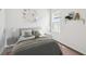 Cozy bedroom with neutral tones, decorative wall art, and a plush, inviting bed at 5914 Bristle Oak St, Mount Dora, FL 32757