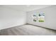 Bright bedroom with carpeting, two windows, and white walls at 5914 Bristle Oak St, Mount Dora, FL 32757