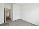 Bedroom with neutral carpet, white walls, baseboards, and door to hall at 5914 Bristle Oak St, Mount Dora, FL 32757