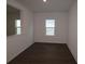 Bright room with dark wood flooring and a window for natural light at 5914 Bristle Oak St, Mount Dora, FL 32757
