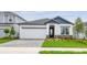 Charming single-Gathering home boasts stone accents, a well-manicured lawn, and an attached two-car garage at 5914 Bristle Oak St, Mount Dora, FL 32757