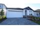 Beautiful single-Gathering home featuring a well-manicured lawn and a paved driveway leading to an attached two-car garage at 5914 Bristle Oak St, Mount Dora, FL 32757