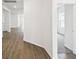 Spacious hallway with wood flooring leads to various rooms, creating an inviting and open atmosphere at 5914 Bristle Oak St, Mount Dora, FL 32757