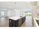 Open concept kitchen with dark island, white countertops, and stainless steel appliances at 5914 Bristle Oak St, Mount Dora, FL 32757