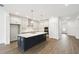 Well-lit kitchen features a large island with seating, stainless steel appliances, and ample counter space at 5914 Bristle Oak St, Mount Dora, FL 32757