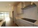 Modern kitchen featuring stainless steel appliances, custom cabinets, and a white tile backsplash at 5914 Bristle Oak St, Mount Dora, FL 32757