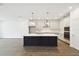 Beautiful kitchen featuring a center island with seating, stainless steel appliances, and stylish pendant lighting at 5914 Bristle Oak St, Mount Dora, FL 32757