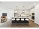Modern kitchen with stainless steel appliances, a large island with seating, and sleek countertops at 5914 Bristle Oak St, Mount Dora, FL 32757