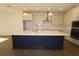 Modern kitchen featuring a large island, stainless steel appliances, custom cabinets, and pendant lighting at 5914 Bristle Oak St, Mount Dora, FL 32757