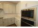 Modern kitchen featuring stainless steel appliances and custom cabinets at 5914 Bristle Oak St, Mount Dora, FL 32757