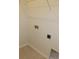 A functional laundry area with tile flooring and utility connections at 5914 Bristle Oak St, Mount Dora, FL 32757