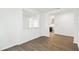 Open living space featuring kitchen in background and dark wood flooring at 5914 Bristle Oak St, Mount Dora, FL 32757
