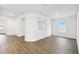 Bright living room with wood flooring, white walls, and ample natural light at 5914 Bristle Oak St, Mount Dora, FL 32757