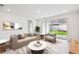 Bright living room features stylish furniture, neutral decor, and sliding glass doors to the backyard at 5914 Bristle Oak St, Mount Dora, FL 32757