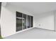Covered patio featuring sliding glass doors and neutral colored flooring at 5914 Bristle Oak St, Mount Dora, FL 32757