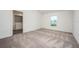 Bright bedroom featuring plush carpet and large window with ample natural light at 113 Cimarron Ln, Poinciana, FL 34759