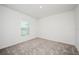 Bright bedroom features neutral carpet and a window bringing in natural light at 113 Cimarron Ln, Poinciana, FL 34759