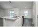 Open kitchen island with granite countertops and stainless steel dishwasher at 113 Cimarron Ln, Poinciana, FL 34759