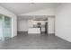 Open floor plan features gray wood flooring, and a view of the kitchen at 113 Cimarron Ln, Poinciana, FL 34759