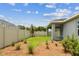 Landscaped backyard featuring a covered patio, fenced perimeter, and verdant lawn, perfect for relaxation at 6051 Sacred Oak Ave, Mount Dora, FL 32757