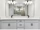Modern bathroom featuring a double vanity with white countertops and black hardware with a view of the shower at 6051 Sacred Oak Ave, Mount Dora, FL 32757