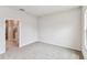 Bedroom features carpeted floors and a doorway to the bathroom at 6051 Sacred Oak Ave, Mount Dora, FL 32757