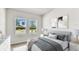 Calm, neutral bedroom with large windows, plush bedding, and elegant decor at 6051 Sacred Oak Ave, Mount Dora, FL 32757