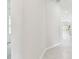 Long hallway with tile flooring leading to a bright living space and bedrooms at 6051 Sacred Oak Ave, Mount Dora, FL 32757