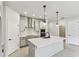 Bright kitchen features a large island, modern appliances, and stylish lighting at 6051 Sacred Oak Ave, Mount Dora, FL 32757