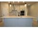 Modern kitchen with island, pendant lighting, and stainless-steel appliances at 6051 Sacred Oak Ave, Mount Dora, FL 32757