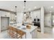 Modern kitchen featuring a large island with seating and stainless steel appliances at 6051 Sacred Oak Ave, Mount Dora, FL 32757