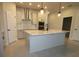 Spacious kitchen featuring a large island, stainless steel appliances, and modern finishes at 6051 Sacred Oak Ave, Mount Dora, FL 32757