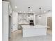 Bright kitchen features a large island, modern appliances, and stylish lighting at 6051 Sacred Oak Ave, Mount Dora, FL 32757