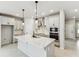 Modern kitchen featuring a large island with seating and stainless steel appliances at 6051 Sacred Oak Ave, Mount Dora, FL 32757