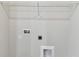 Laundry room with washer hookups, shelf and access for a dryer, providing convenience at 6051 Sacred Oak Ave, Mount Dora, FL 32757