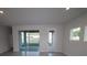 Bright living room with access to the patio through sliding glass doors at 6051 Sacred Oak Ave, Mount Dora, FL 32757