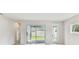 Light-filled living room showcasing sliding glass doors to the patio and a window at 6051 Sacred Oak Ave, Mount Dora, FL 32757