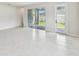 Spacious living room with tile flooring and access to the outdoor patio at 6051 Sacred Oak Ave, Mount Dora, FL 32757